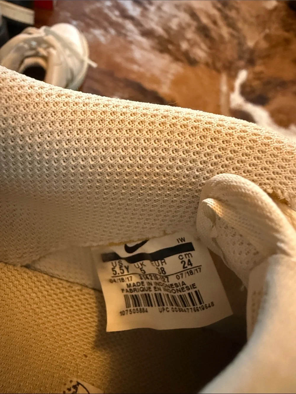 Nike low top Air Force ones. All white with gold swoosh.